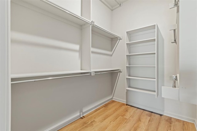 9233 SW 48th Ter, Oklahoma City, OK 73179 - walk in closet with wood finished floors