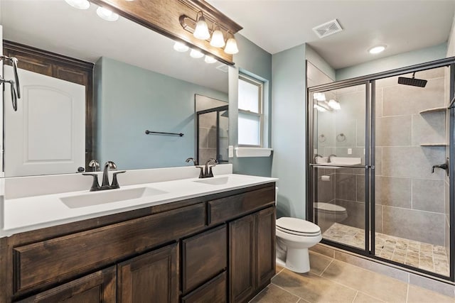 9233 SW 48th Ter, Oklahoma City, OK 73179 - bathroom with toilet, a stall shower, a sink, and visible vents