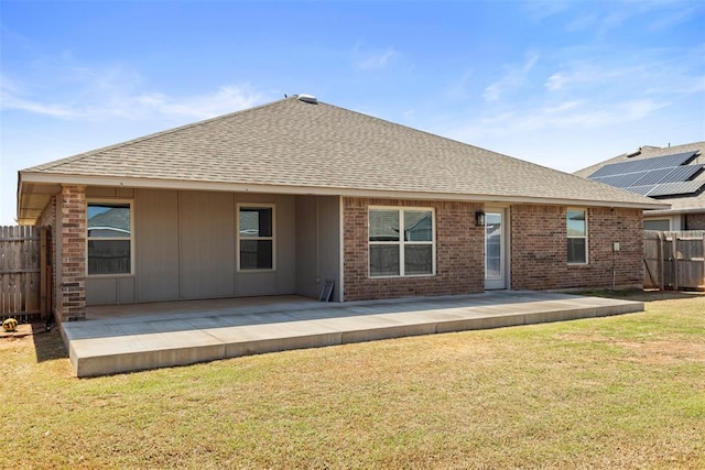 9233 SW 48th Ter, Oklahoma City, OK 73179 - rear view of property featuring a patio, a yard, a shingled roof, and fence