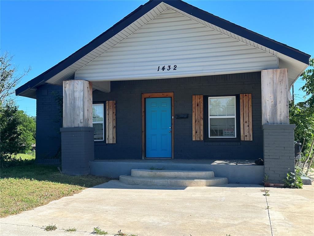 1432 NE 12th St, Oklahoma City, OK 73117 - bungalow featuring a porch and brick siding