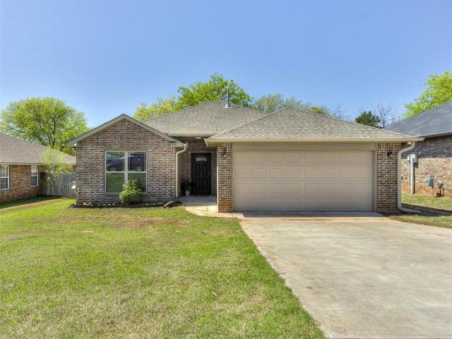 ranch-style house featuring roof with shingles, driveway, a front lawn, brick siding, and a garage