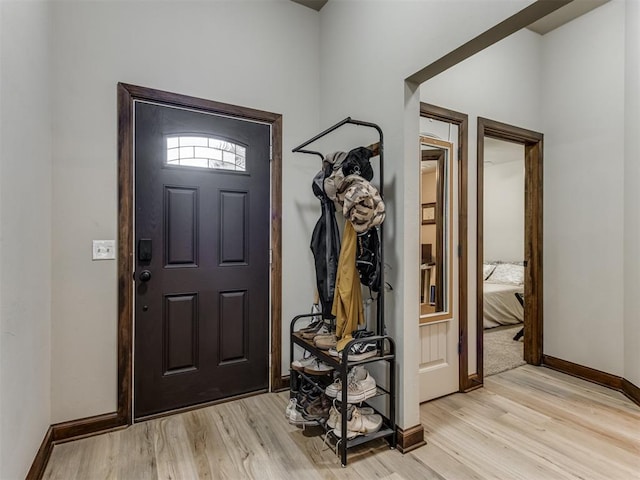 foyer with baseboards and light wood finished floors