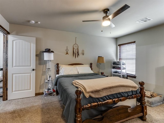 carpeted bedroom with visible vents and ceiling fan