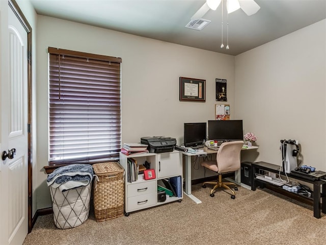 carpeted office with visible vents and a ceiling fan