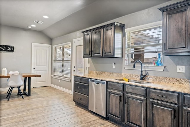 kitchen with light wood-style floors, stainless steel dishwasher, visible vents, a sink, and lofted ceiling