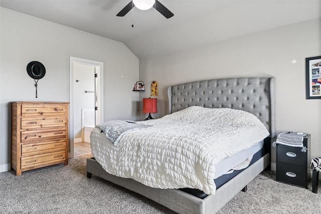 carpeted bedroom with baseboards, ceiling fan, and vaulted ceiling
