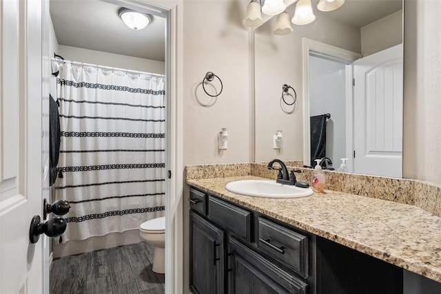 bathroom with shower / bathtub combination with curtain, vanity, toilet, and wood finished floors