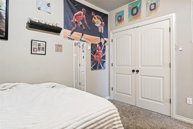 bedroom with a closet, baseboards, and carpet floors