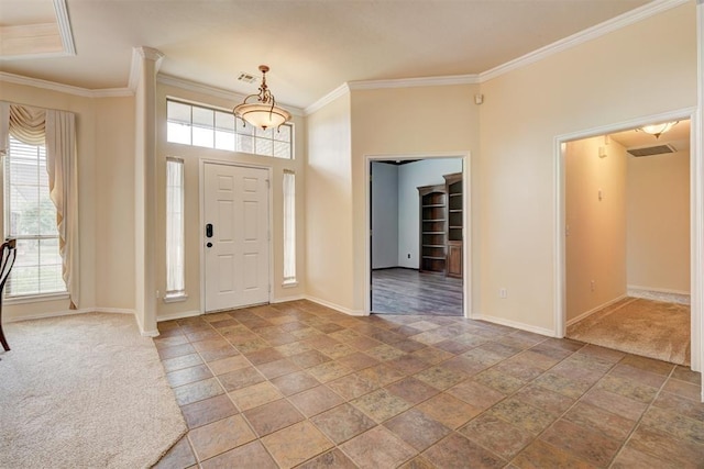 entryway with baseboards, ornamental molding, and a healthy amount of sunlight