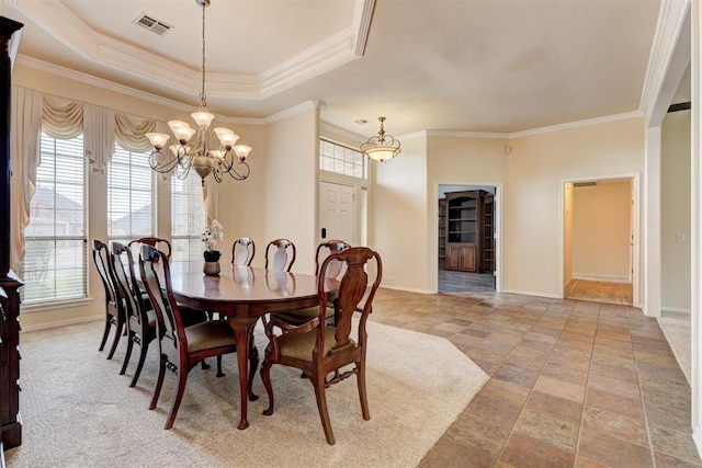 dining room with baseboards, crown molding, a chandelier, and visible vents