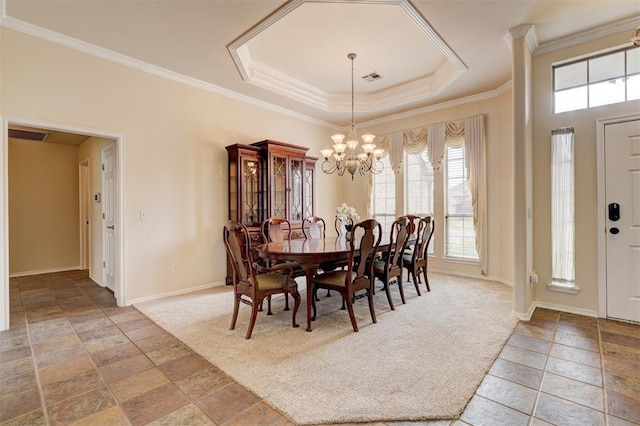 dining space featuring baseboards, ornamental molding, a chandelier, and a healthy amount of sunlight