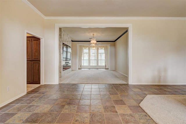 unfurnished room with baseboards, ornamental molding, stone finish flooring, and a notable chandelier