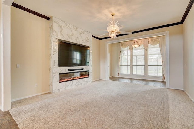 unfurnished living room with baseboards, ornamental molding, carpet flooring, and a fireplace