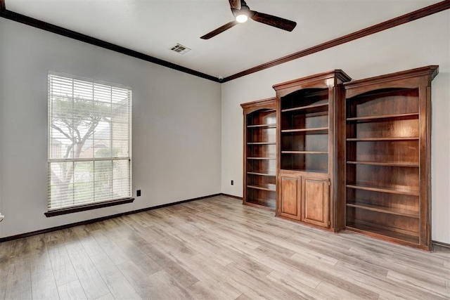 empty room with visible vents, ornamental molding, baseboards, light wood-type flooring, and a ceiling fan