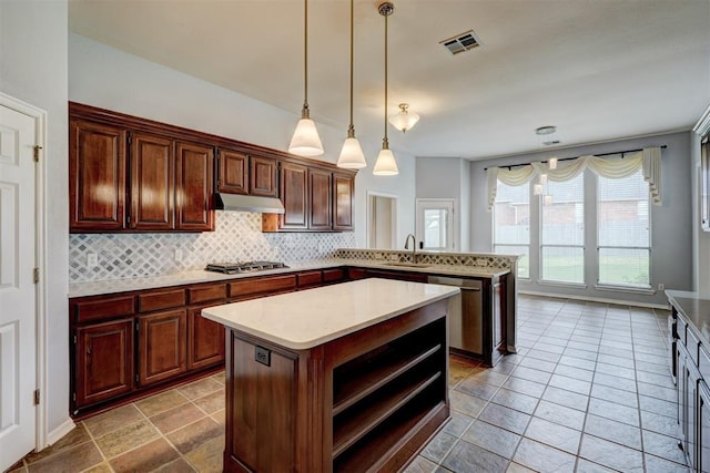 kitchen featuring a sink, light countertops, stainless steel appliances, tasteful backsplash, and visible vents