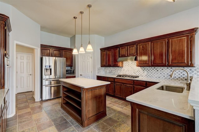 kitchen with a sink, decorative backsplash, appliances with stainless steel finishes, and under cabinet range hood