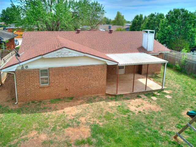 901 Richmond St, Yukon, OK 73099 - rear view of house with a fenced backyard, a yard, a patio area, and brick siding