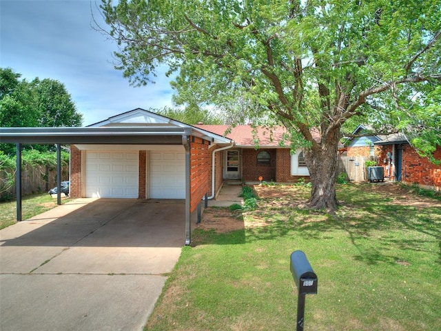 901 Richmond St, Yukon, OK 73099 - ranch-style house with a front lawn, central AC unit, concrete driveway, brick siding, and an attached garage