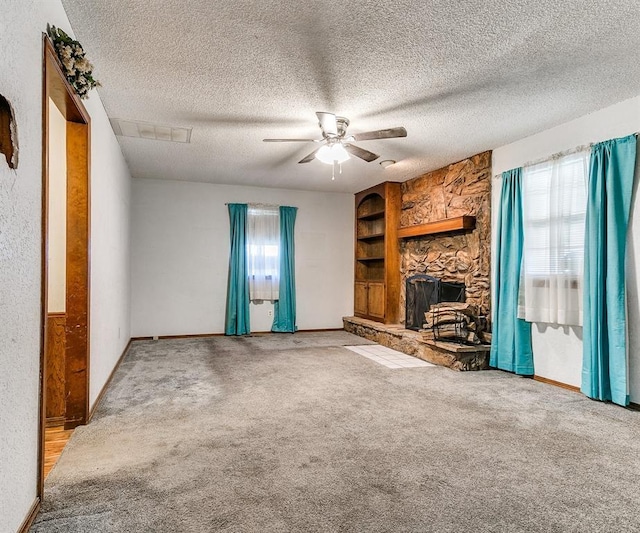 901 Richmond St, Yukon, OK 73099 - unfurnished living room with carpet, a textured ceiling, and a fireplace