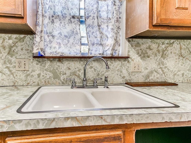 901 Richmond St, Yukon, OK 73099 - room details with light countertops, decorative backsplash, brown cabinets, and a sink