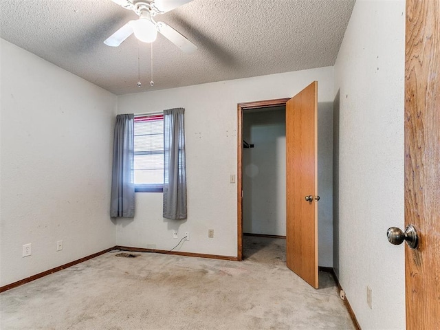 901 Richmond St, Yukon, OK 73099 - unfurnished bedroom with baseboards, a ceiling fan, carpet flooring, and a textured ceiling