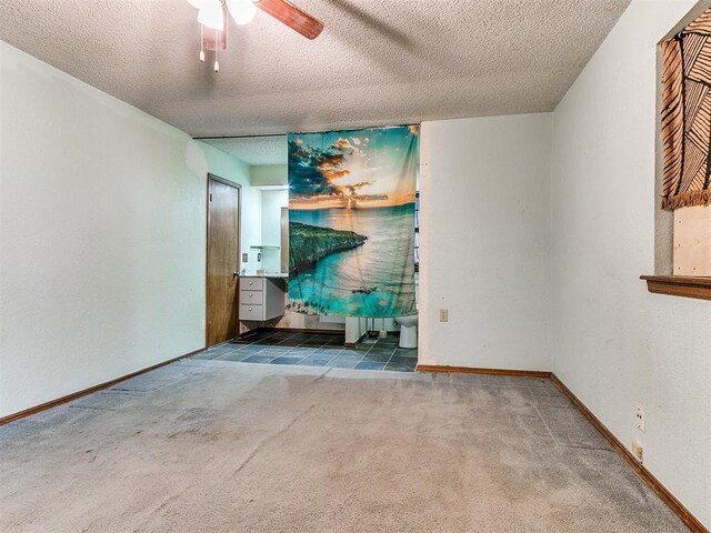 901 Richmond St, Yukon, OK 73099 - unfurnished living room featuring a textured ceiling, carpet flooring, baseboards, and ceiling fan