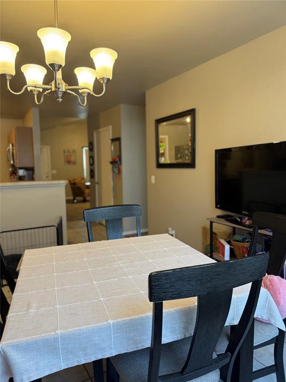 dining space featuring a notable chandelier