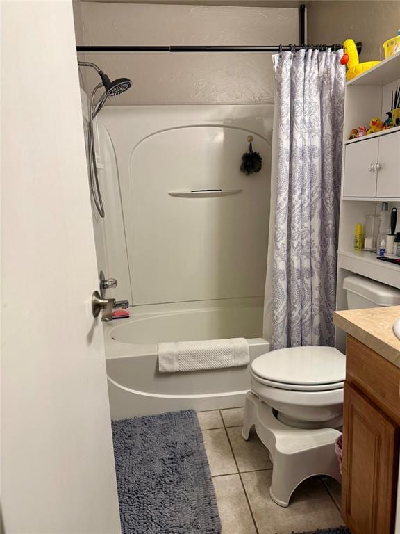 bathroom featuring toilet, tile patterned floors, vanity, and shower / tub combo with curtain