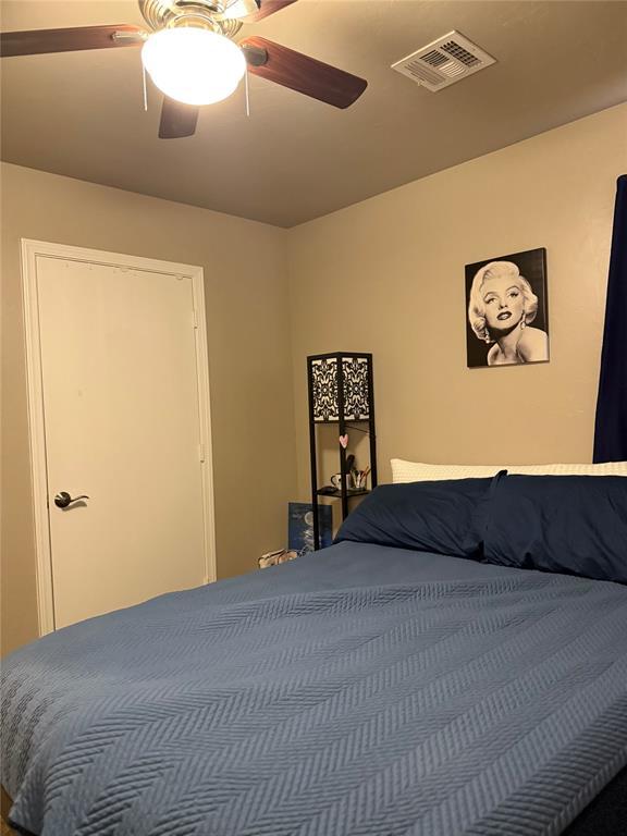bedroom featuring visible vents and ceiling fan
