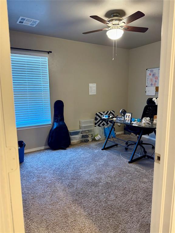 home office with visible vents, ceiling fan, baseboards, and carpet floors