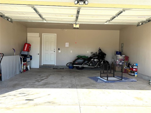 garage with a garage door opener and electric panel