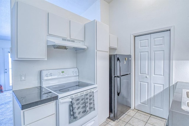 3003 River Oaks Dr Unit 215, Norman, OK 73072 - kitchen with under cabinet range hood, white range with electric cooktop, freestanding refrigerator, white cabinets, and light tile patterned flooring