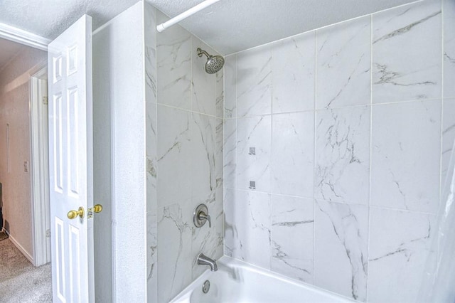 3003 River Oaks Dr Unit 215, Norman, OK 73072 - bathroom featuring a textured ceiling and shower / washtub combination