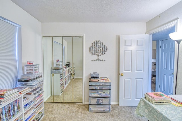 3003 River Oaks Dr Unit 215, Norman, OK 73072 - carpeted bedroom with a textured ceiling and a closet