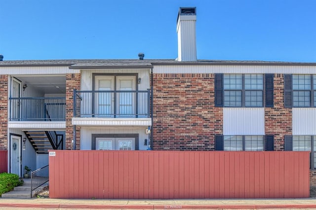 3003 River Oaks Dr Unit 215, Norman, OK 73072 - view of property exterior with stairway and brick siding