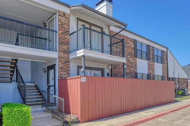 3003 River Oaks Dr Unit 215, Norman, OK 73072 - view of property with stairway, central air condition unit, and fence