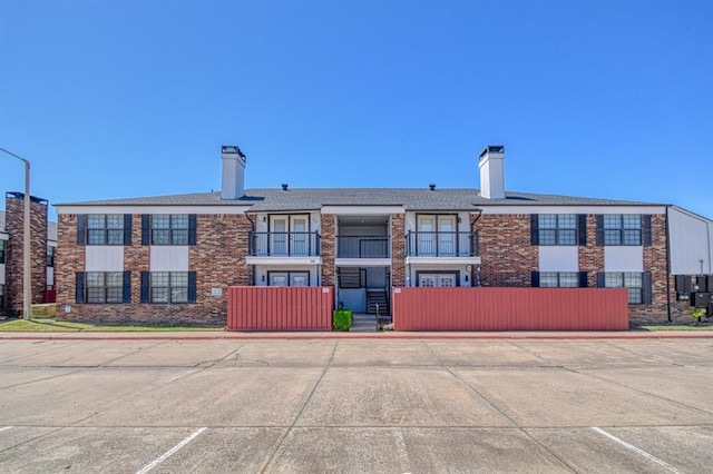 3003 River Oaks Dr Unit 215, Norman, OK 73072 - view of property featuring uncovered parking