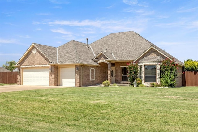 18395 Wild Horse Trl, Norman, OK 73072 - view of front of home with an attached garage, a front yard, and fence