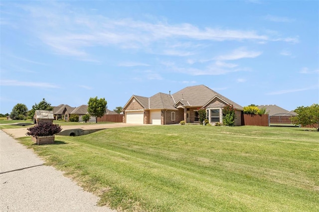 18395 Wild Horse Trl, Norman, OK 73072 - view of front facade with a front yard, driveway, fence, and an attached garage