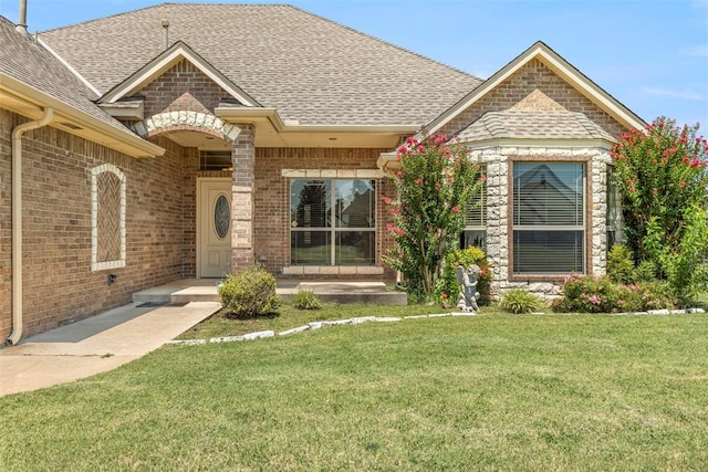 18395 Wild Horse Trl, Norman, OK 73072 - french country style house with a front yard, a shingled roof, and brick siding
