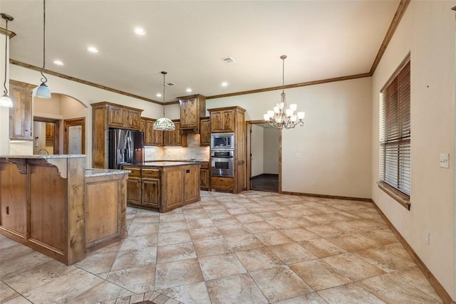 18395 Wild Horse Trl, Norman, OK 73072 - kitchen with brown cabinetry, a chandelier, baseboards, and stainless steel appliances