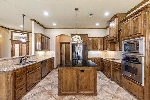 18395 Wild Horse Trl, Norman, OK 73072 - kitchen with dark stone counters, arched walkways, appliances with stainless steel finishes, and a sink