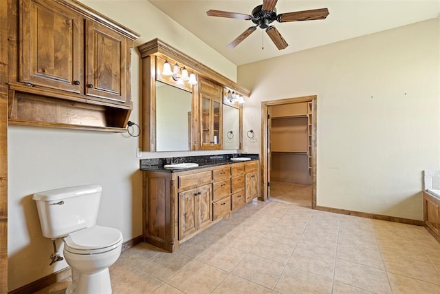 18395 Wild Horse Trl, Norman, OK 73072 - bathroom featuring baseboards, toilet, ceiling fan, double vanity, and tile patterned flooring
