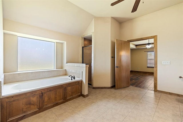 18395 Wild Horse Trl, Norman, OK 73072 - full bath featuring a garden tub, ceiling fan, a shower stall, vaulted ceiling, and tile patterned floors