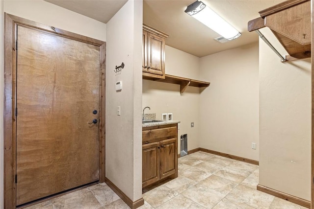 18395 Wild Horse Trl, Norman, OK 73072 - clothes washing area featuring cabinet space, baseboards, hookup for a washing machine, and a sink