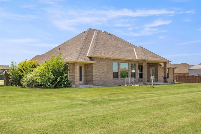 18395 Wild Horse Trl, Norman, OK 73072 - rear view of property with brick siding, ceiling fan, fence, and a lawn