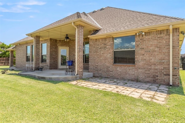 18395 Wild Horse Trl, Norman, OK 73072 - back of house featuring ceiling fan, a yard, a patio, brick siding, and a shingled roof