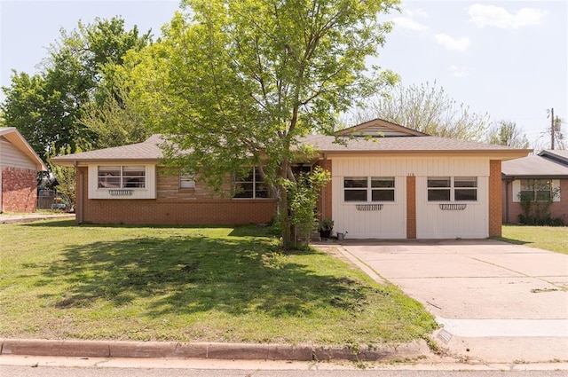 ranch-style home featuring concrete driveway, a front yard, and brick siding