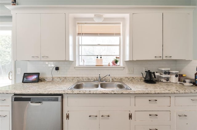kitchen with a sink, backsplash, white cabinetry, and dishwasher
