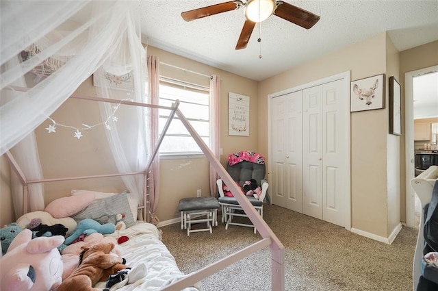 carpeted bedroom featuring a textured ceiling, a closet, ceiling fan, and baseboards